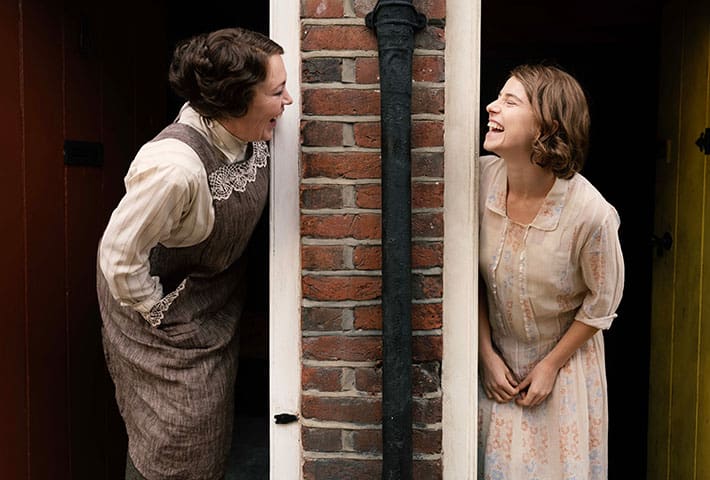 Olivia Colman as Edith and Jessie Buckley as Rose laughing with one another