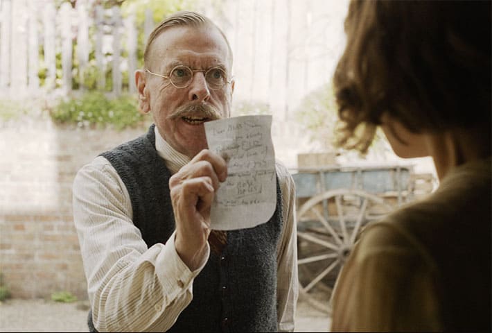 Timothy Spall as Edward holding up one of the letters