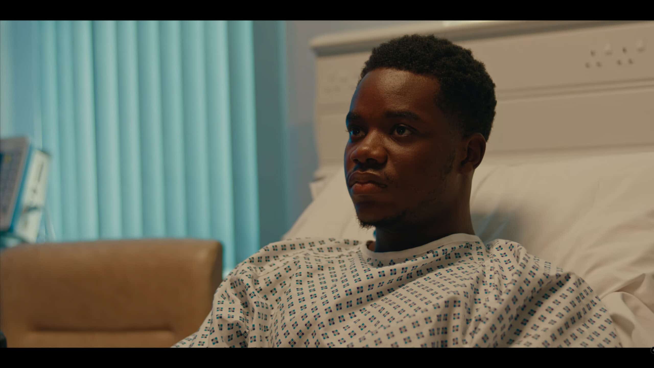 Josh Tedeku as Tazer in a hospital bed