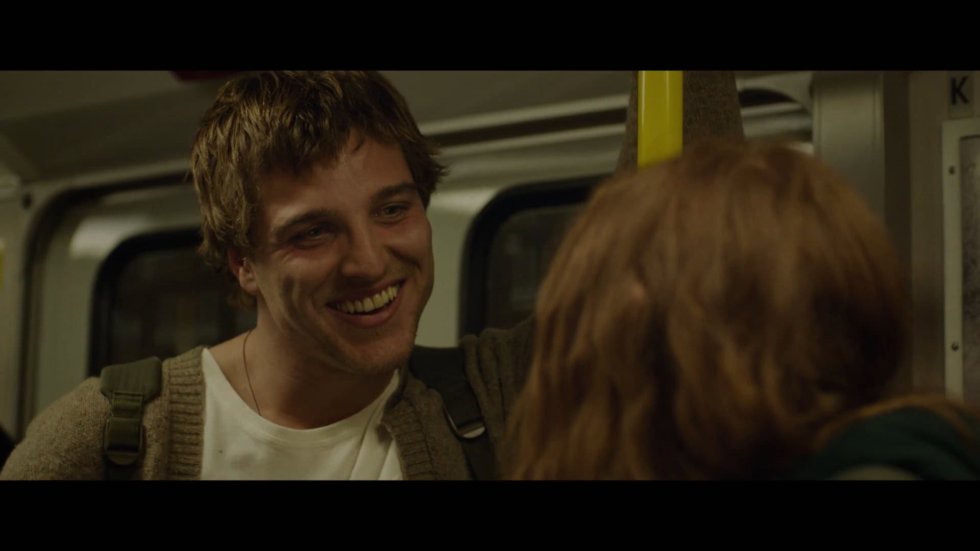 Martin as Jonas Dassler smiling at Mazzy on the train
