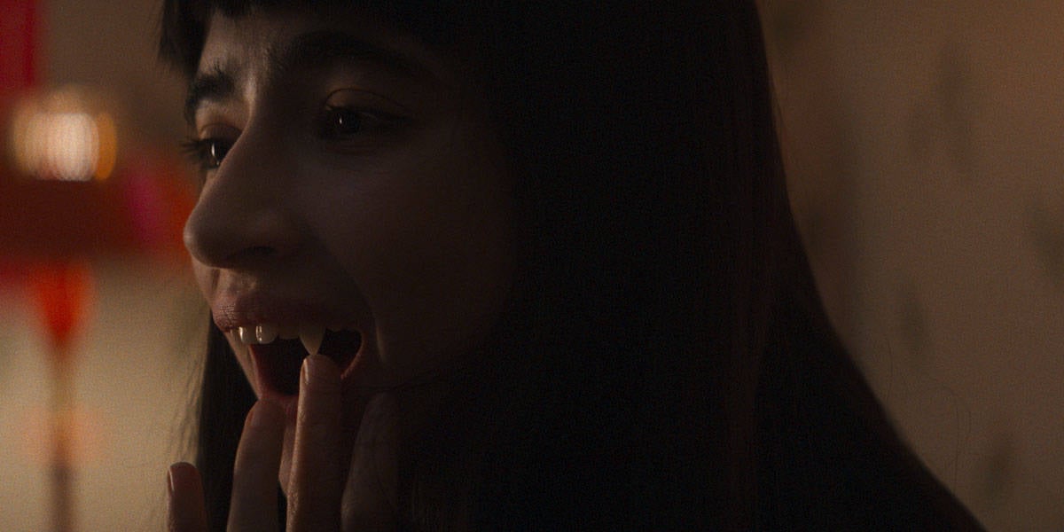 Sasha (Sara Motpetit) checking her teeth that have come in, Humanist Vampire Seeking Consenting Suicidal Person, directed by Ariane Louis-Seize, 2024, (Drafthouse Films)