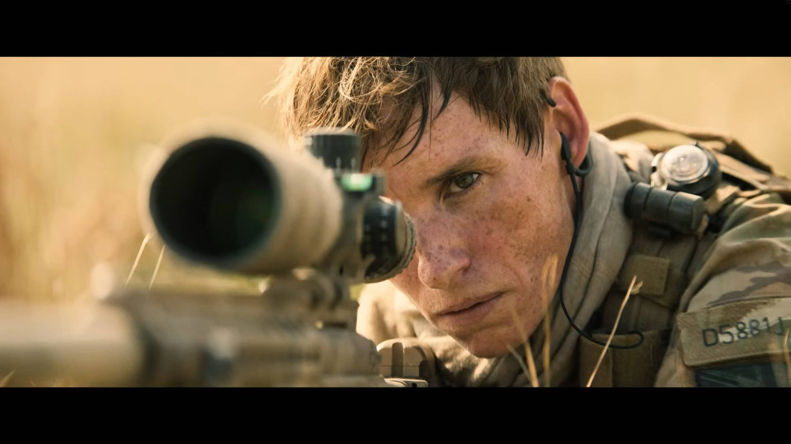 Alexander (Eddie Redmayne) looking down the scope of a rifle