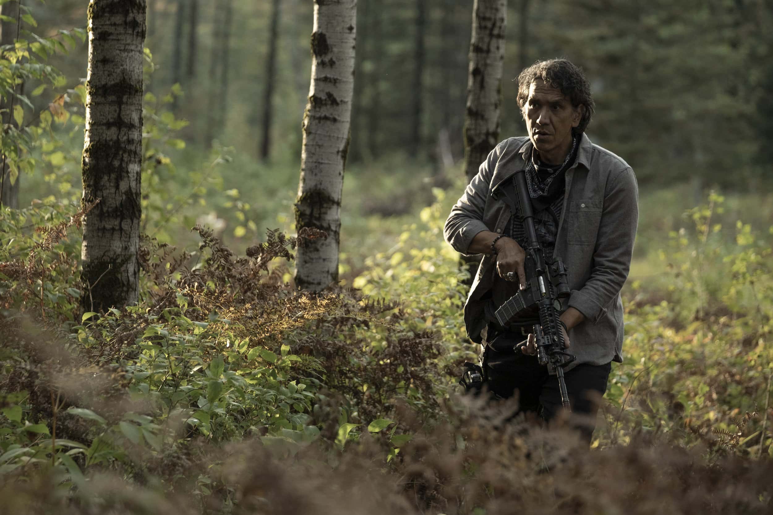 Galen (Michael Greyeyes) checking the perimeter with a gun in hand – 40 Acres
