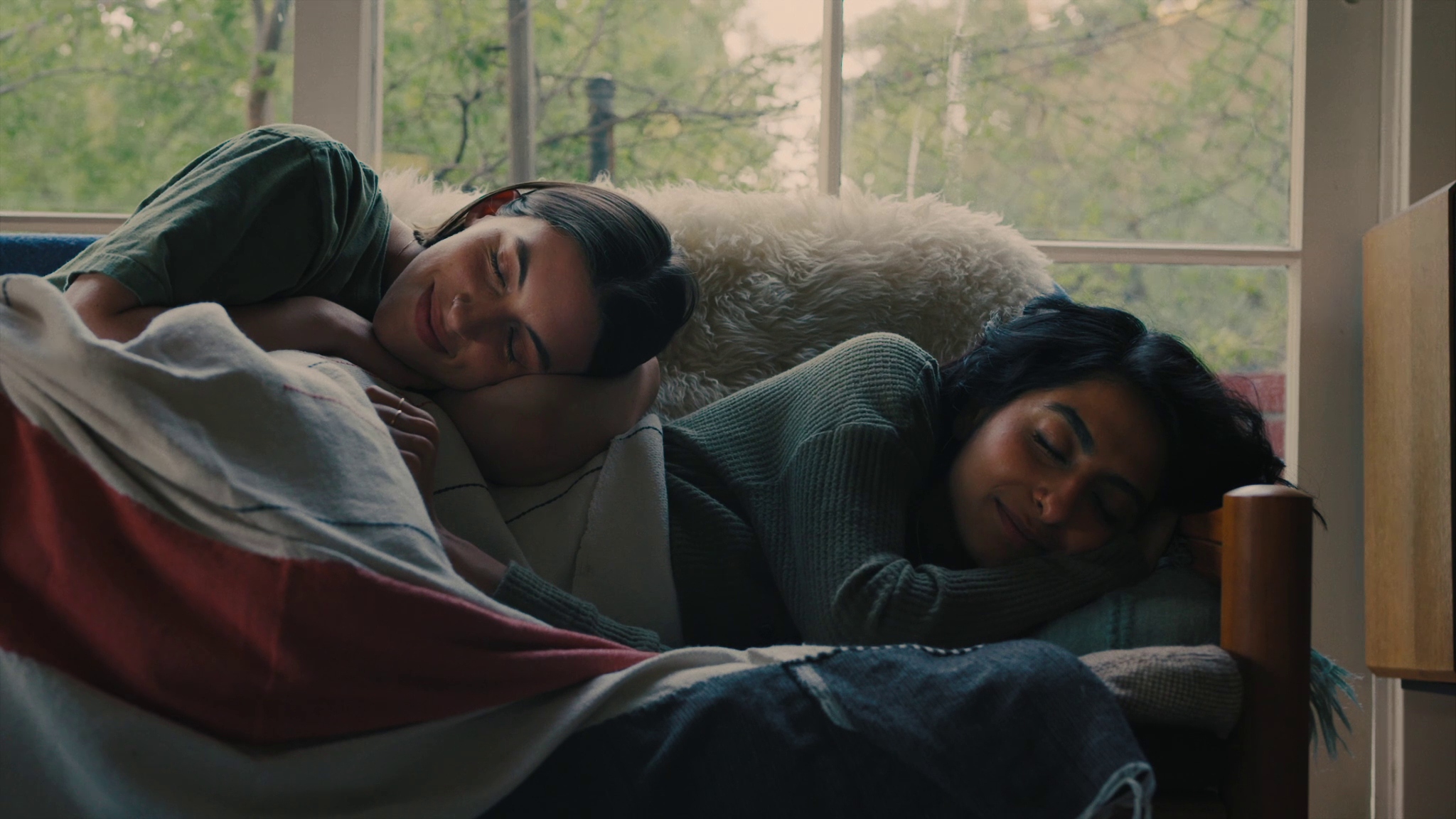 Lou (Susie Yankou) and Priya (Kausar Mohammed) napping after a night drinking and having fun