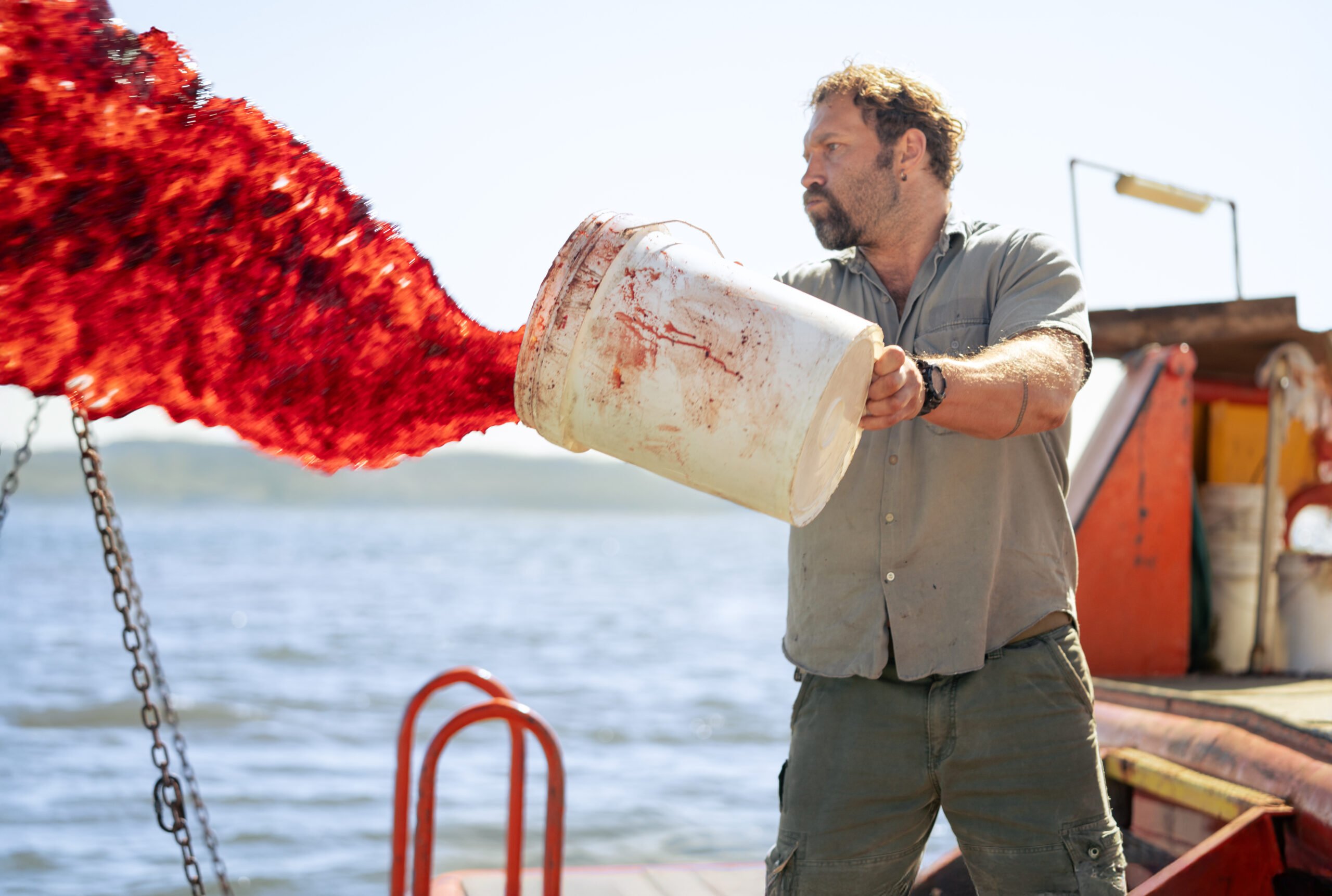 Tucker (Jai Courtney) throwing blood overboard | Tucker Jai Courtney – Dangerous Animals 4 scaled Tucker (Jai Courtney) throwing blood overboard