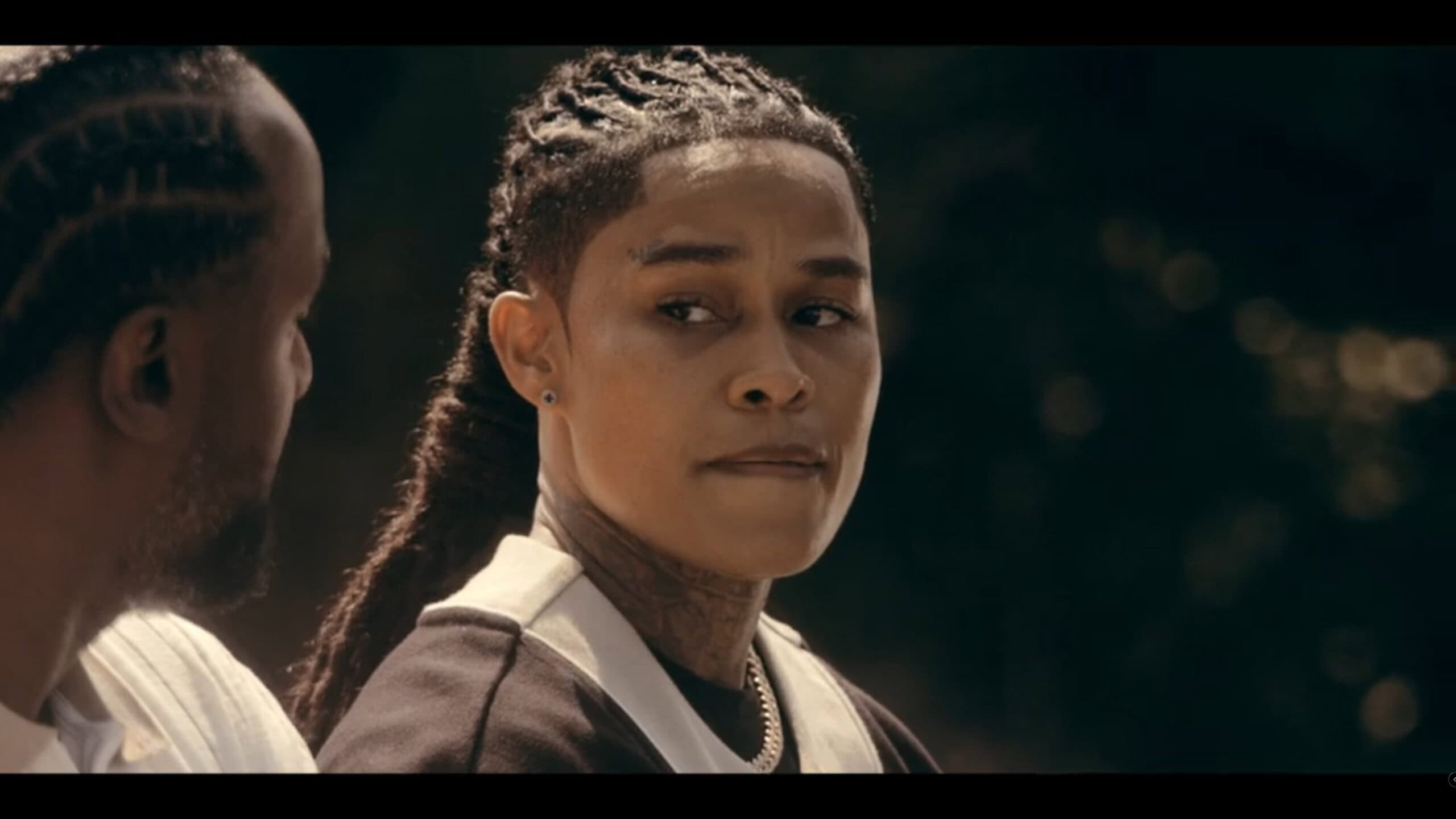 Jackie (Aina Brei’Yon) hearing about a job from Reg - The Chi Season 7 Episode 9