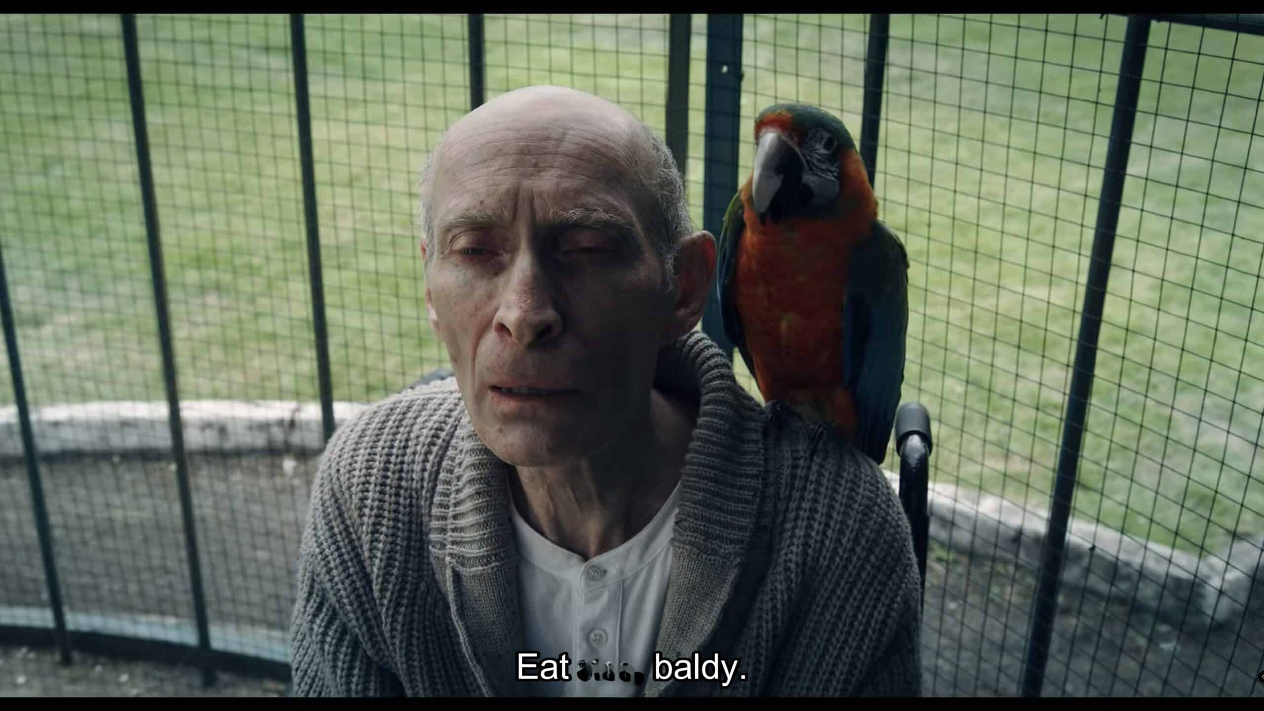 Augustus Stonehurst (Philip Philmar) potentially having a parrot speak for him - Wednesday Season 2 Episode 4