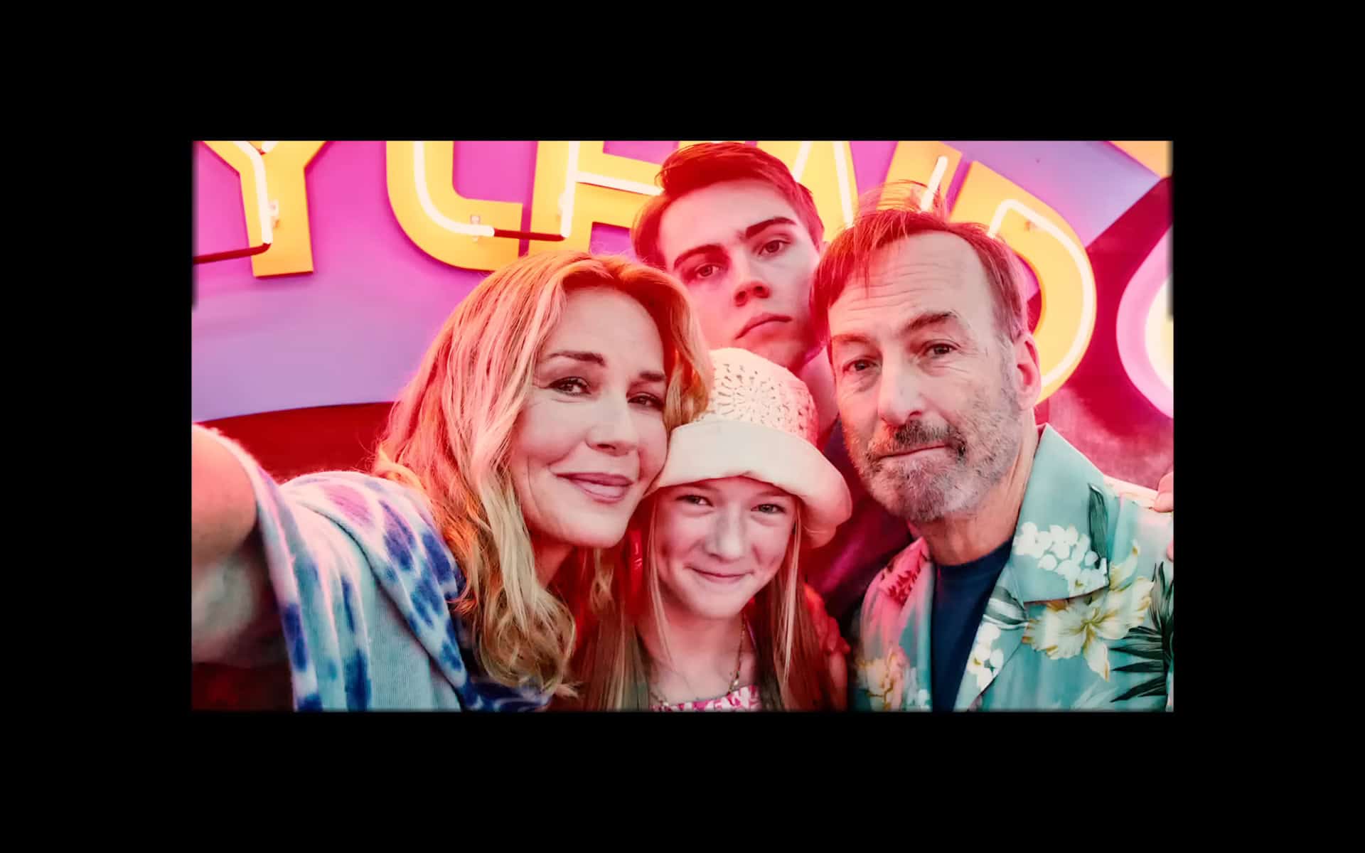 Becca (Connie Nielsen), Brady (Gage Munroe), Sammy (Paisley Cadorath), and Hutch (Bob Odenkirk) in a family photo – Nobody 2