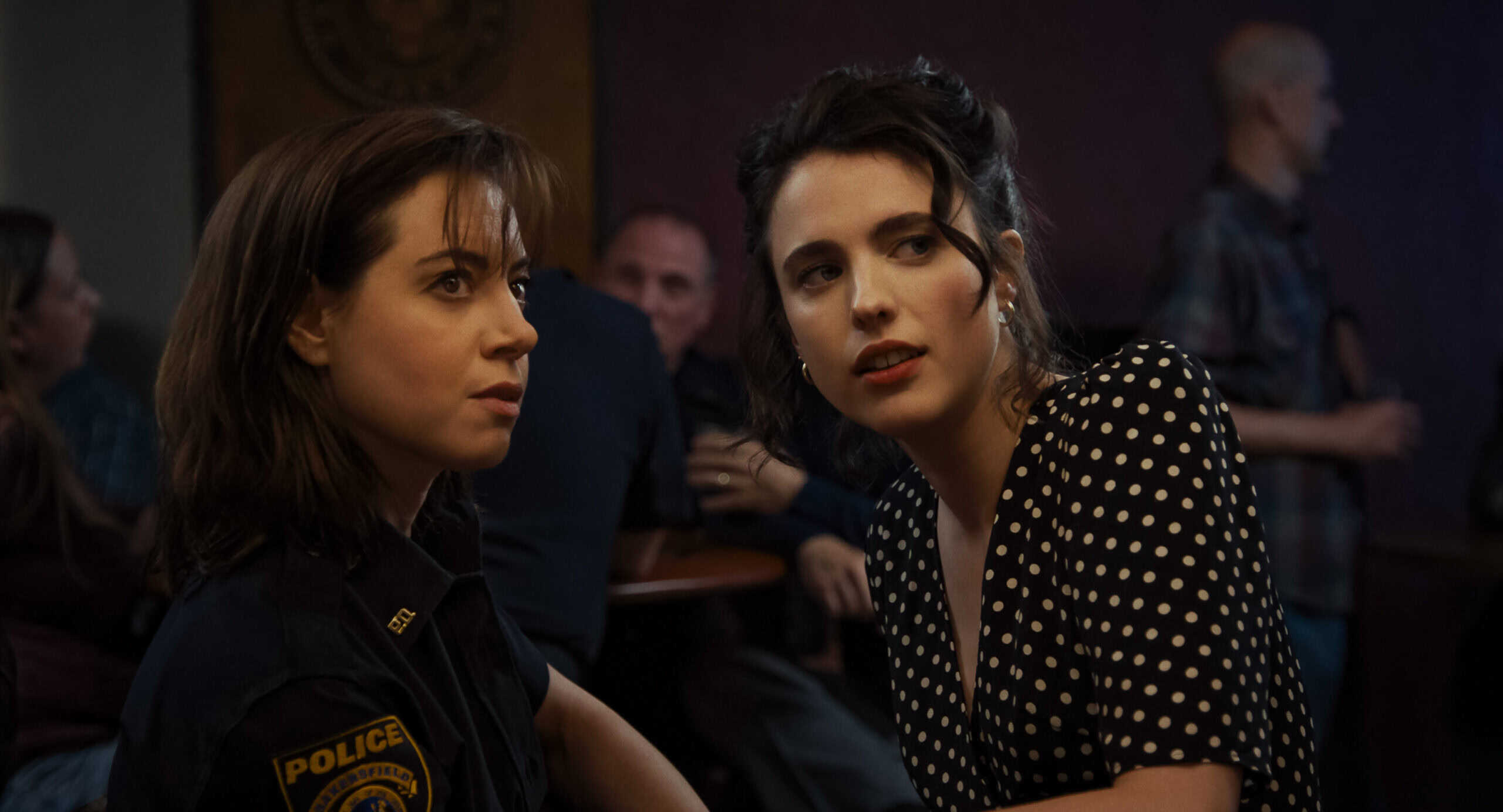 Mary Grace “MG” Falcone (Aubrey Plaza) and Honey (Margaret Qualley) having a side conversation – Honey Don’t