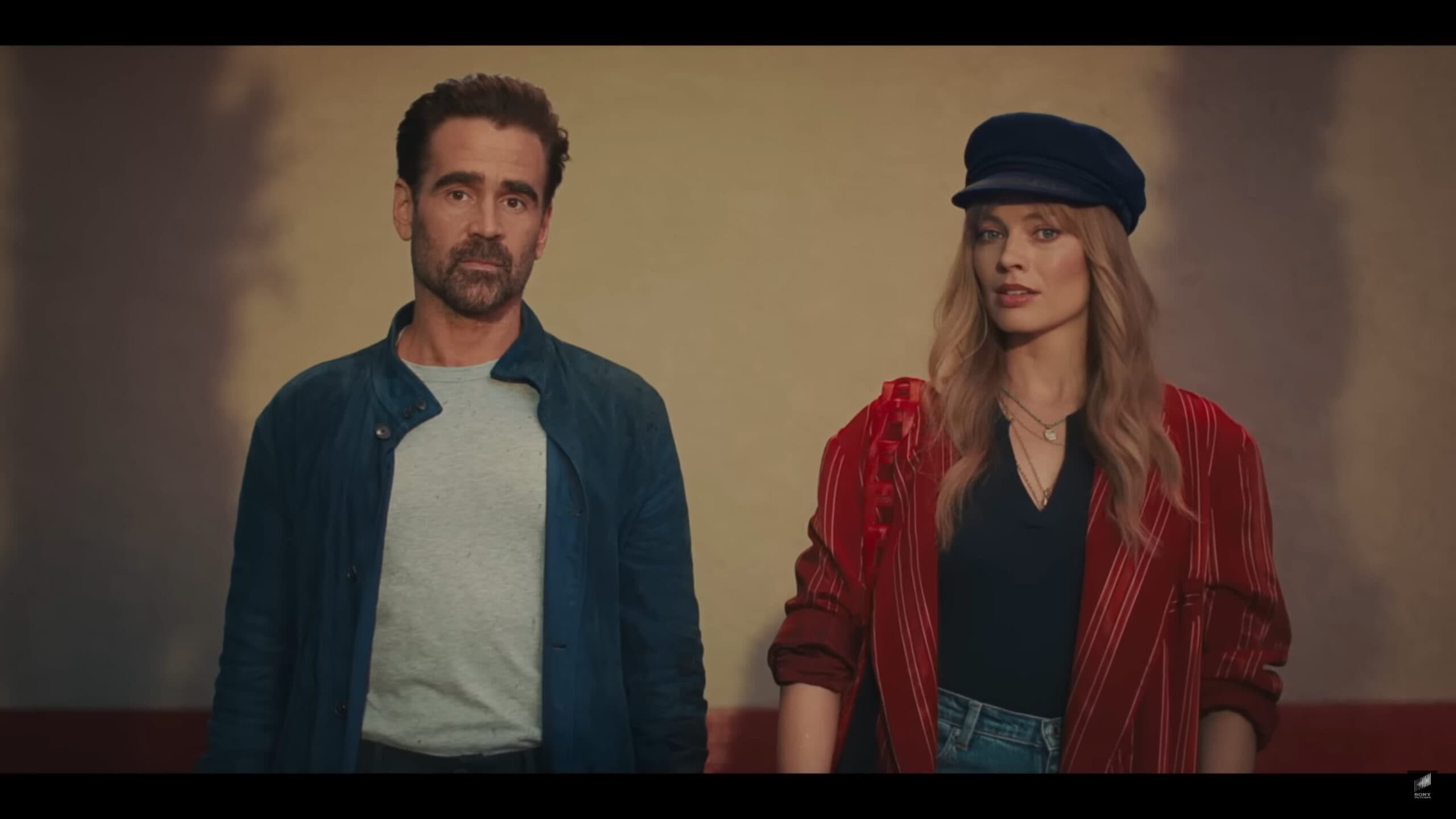 David (Colin Farrell) and Sarah (Margot Robbie) standing side by side – A Big Bold Beautiful Journey