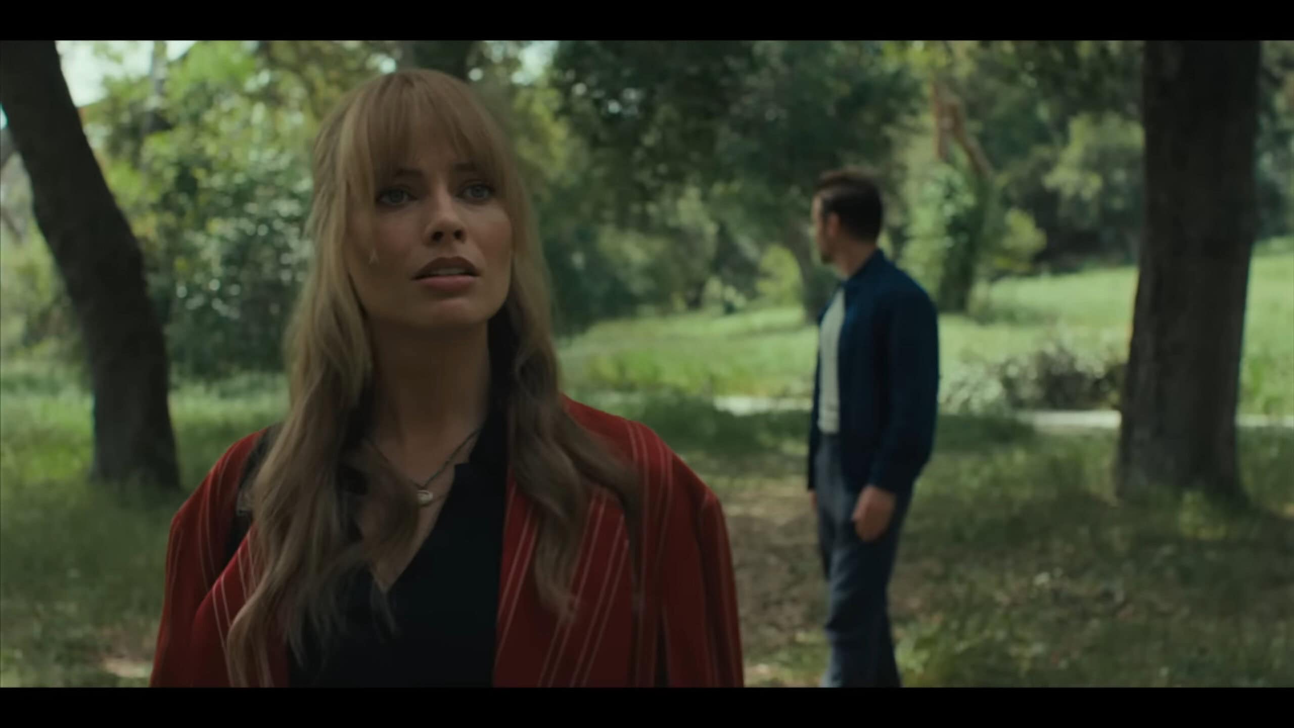 Sarah (Margot Robbie) standing in front of one of the first doors – A Big Bold Beautiful Journey