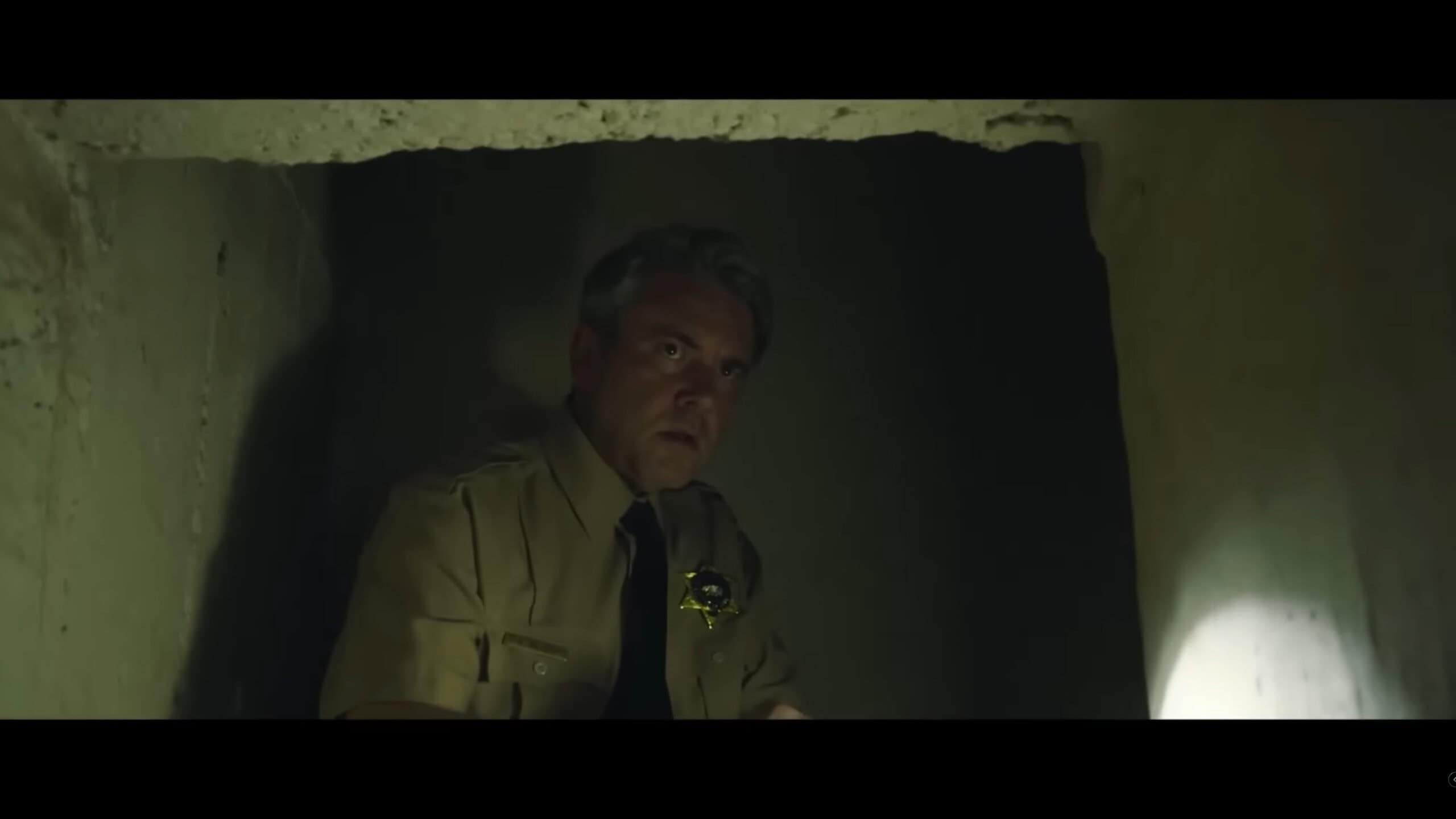 Sheriff Miller (AJ Bowen) exploring a basement – Traumatika