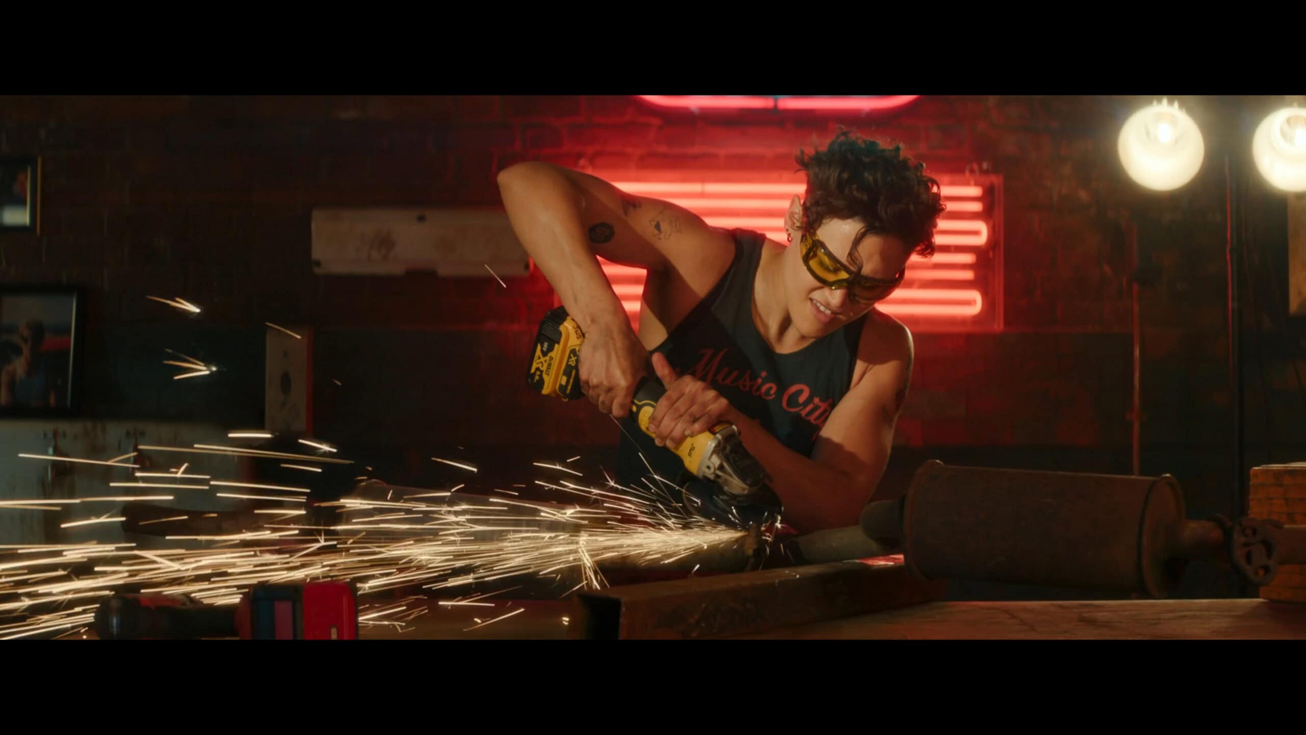 Kam (Katy O’Brian) working on a car – Maintenance Required