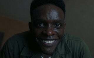 Hallorann smiling in a creepy way at Taniel - IT – Welcome To Derry Season 1 Episode 4