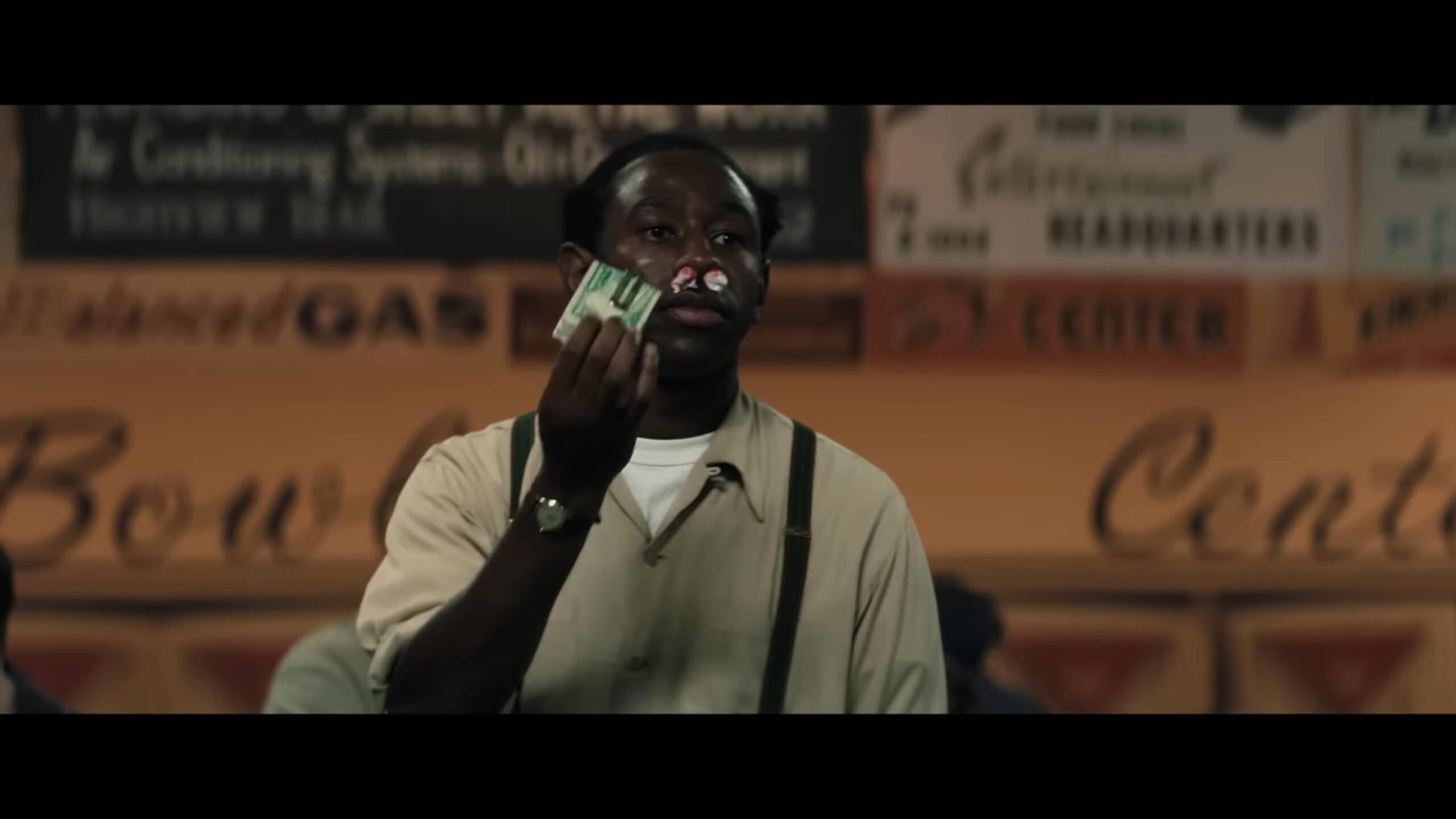 Wally (Tyler Okonma) holding a wad of money for a bet, that is part of a con him and Marty are running in New Jersey in Marty Supreme